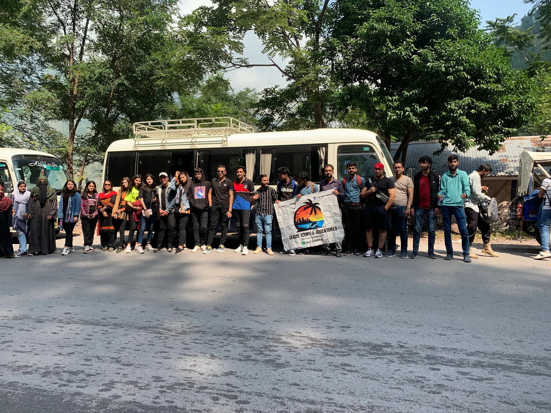 Large Lexuz Tours group gathered beside a coach